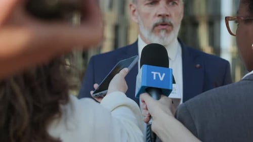 Man Giving Press Conference to Reporters