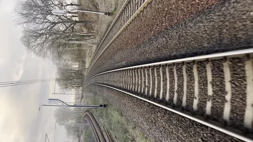 Vertical View on Railroad Track From the Back Window of Fast Train Bullet Train Rides on the Railway