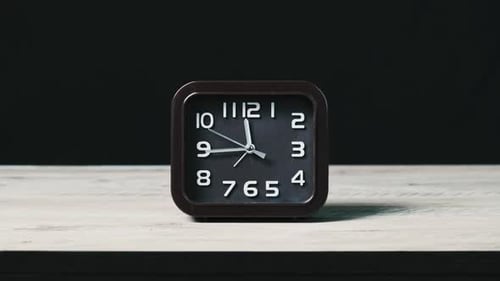 Analog Clock on Wooden Table and Black Background Show Time