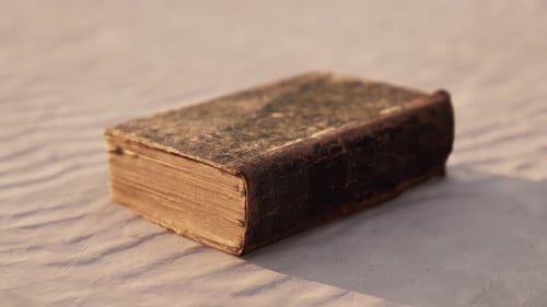 Old Book on the Sand Beach