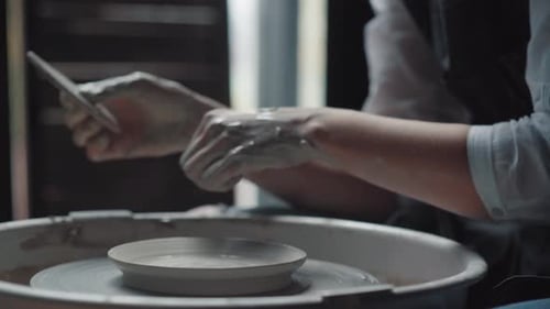 Hands Shaping Clay on a Pottery Wheel