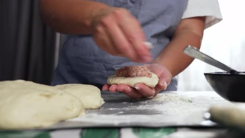 Woman Preparing Traditional Meat Pies By Hand in Home Kitchen