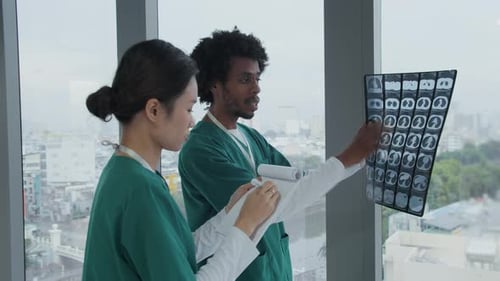 Two Radiologists Discussing MRI of Patient