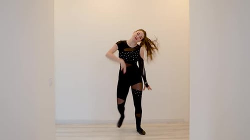 Young Woman Dancing in a Brightly Lit Room