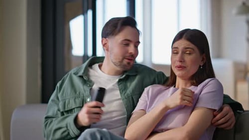 Young Sweethearts Watching Thriller Together at Couch Closeup Woman Man Afraid