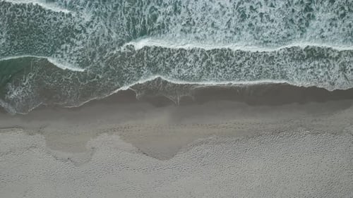 (Top down view) Aerial view drone over beach sea with powerful sea waves. Beach sand in Sardinia, It