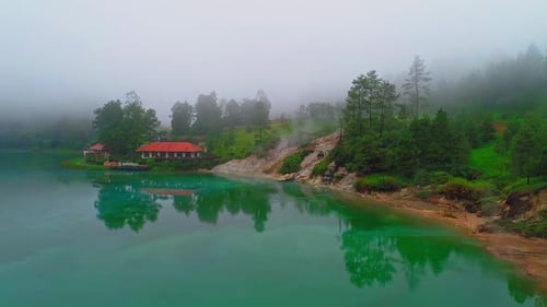 Reflection of a house on the edge of a lake