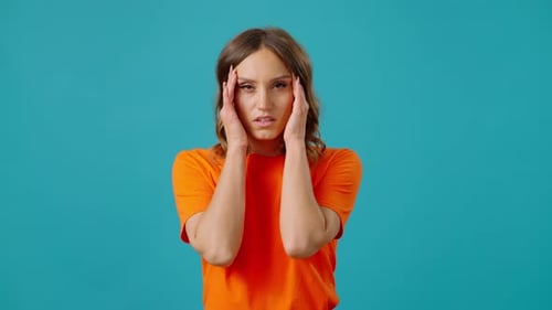 Woman Experiencing Headache on Blue Background