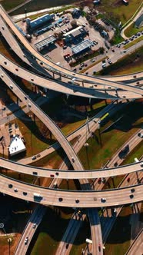 Lots of cars run by the roads of Dallas, Texas, USA. Drone descending above the highways