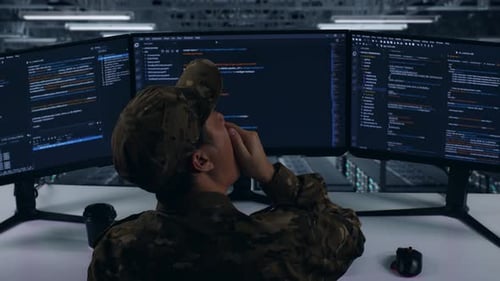 Back View Of Tired Asian Military Yawning While Write Code In Data Center