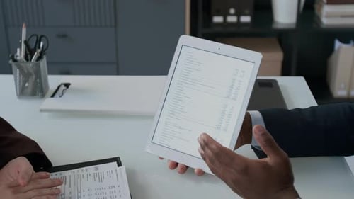 Teamwork Looking at Data on a Tablet in Office
