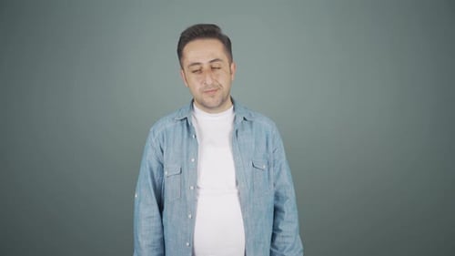 Man Rolls Head and Crosses Arms