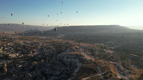 Aerial View of Cappadocia, Turkey and Colorful Hot Air Balloons Flying Above Landscape on Sunny Summ