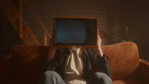 Television Static Covers Head of Person on Couch