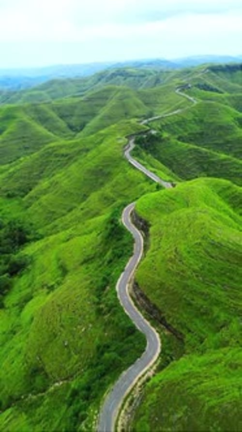 aerial view of sumba hill with winding road, indonesia