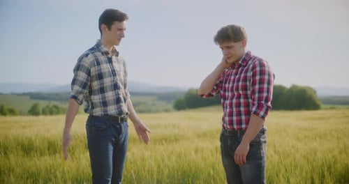 Two Male Farmers Discussing In Field Agriculture Crops Business Talking