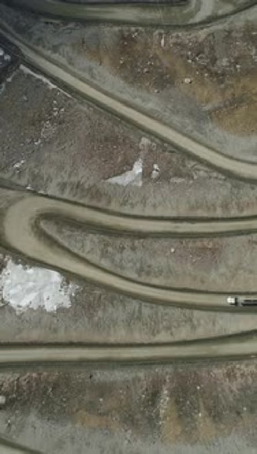 Trucks Go on High Mountain Road Pass Aerial Vertical TopDown View Vertical Video