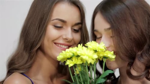 Girls Sniffing Flowers