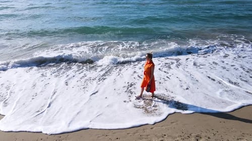 Woman Walking On The Beach