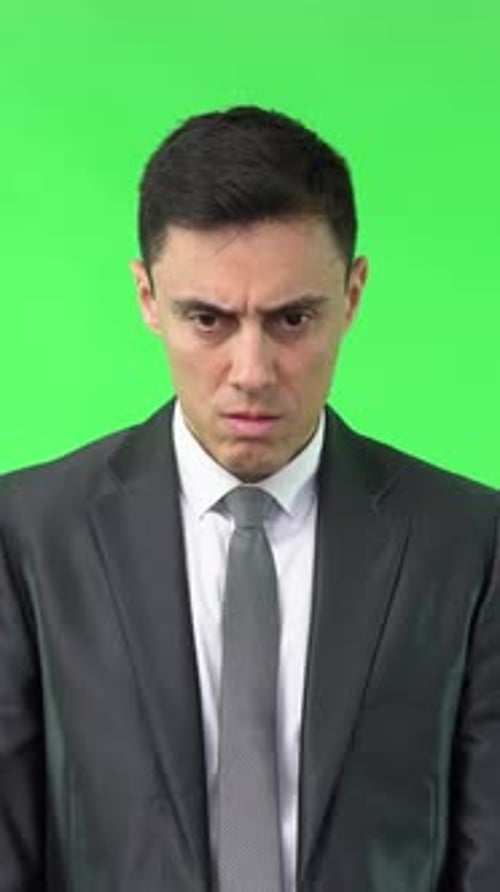 Shocked Man in Suit Against Green Screen