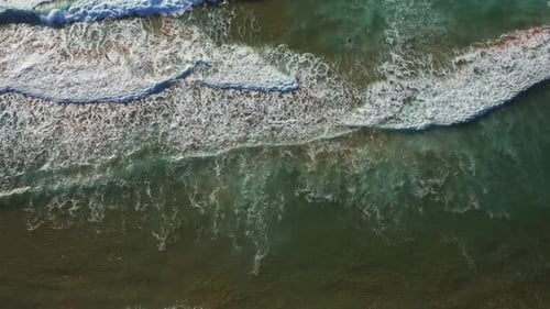Aerial View Giant Ocean Waves Crashing and Foaming on Beach