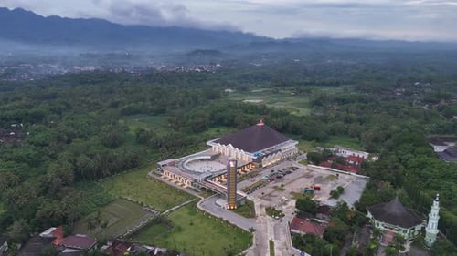 Drone view of The magnificent and beautiful mosque is located in the middle of green land.