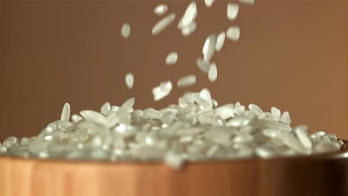 The Rice Falls Into a Wooden Bowl Filmed on a Highspeed Camera at 1000 Fps