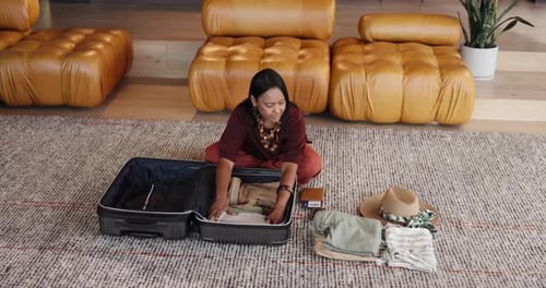 Woman Packs Suitcase for Travel at Home