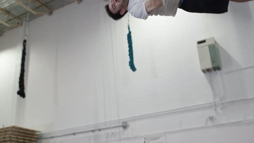 Man Does Backflip on Trampoline Indoors