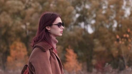 Woman with Sunglasses in Autumn Nature Scene