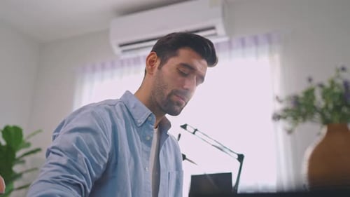 Man Singing Into a Microphone at Home