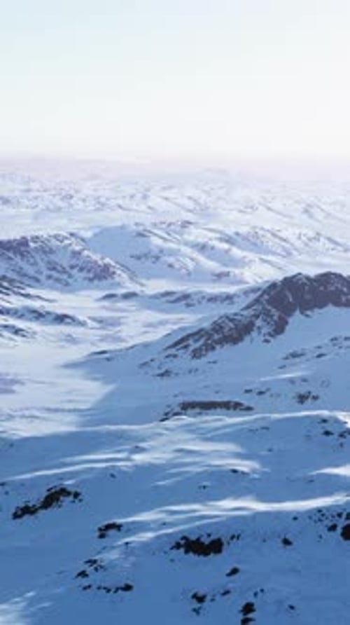 A Snowcovered Mountain Range with Majestic Peaks in the Background