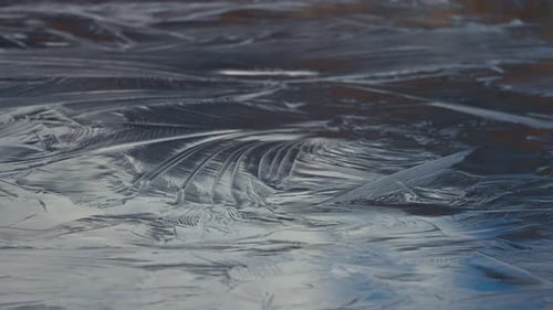 Abstract patterns on the frozen surface of the small pond.