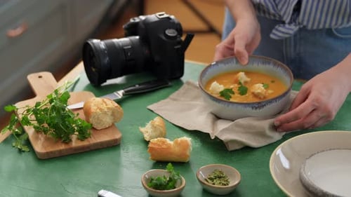 Food Photographer Styling Soup for Camera