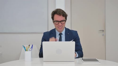 Excited Man Celebrating Success at Work
