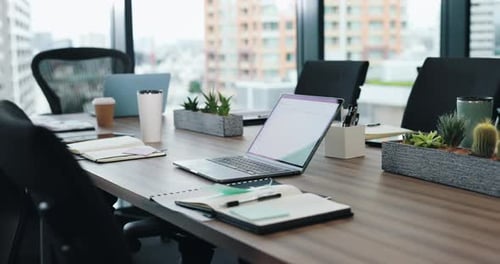 Empty office, laptop on table and meeting room in company for seminar, conference and planning