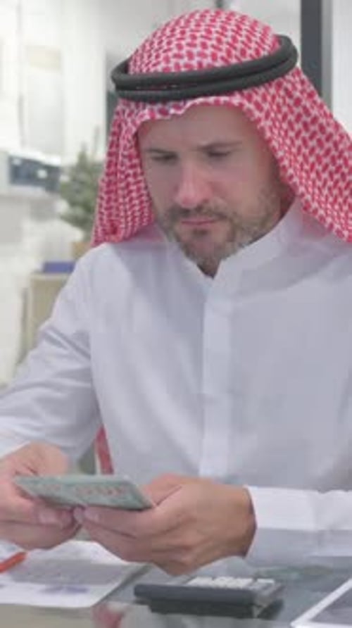 Man Counting Money in Office Setting