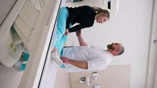 A doctor consults a patient in a medical clinic before an X-ray computed tomography procedure