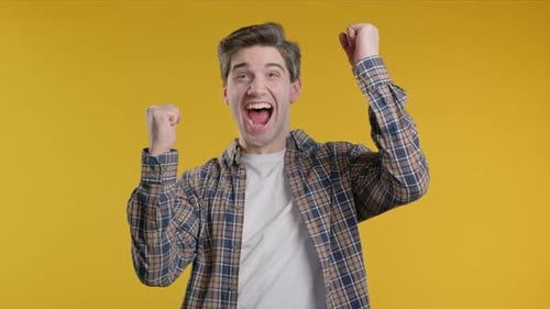 Excited Man Cheers with Clenched Fists