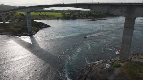 Powerful Tidal Currents Swirl Beneath the Bridge as a Boat Navigates the Famous Maelstrom at