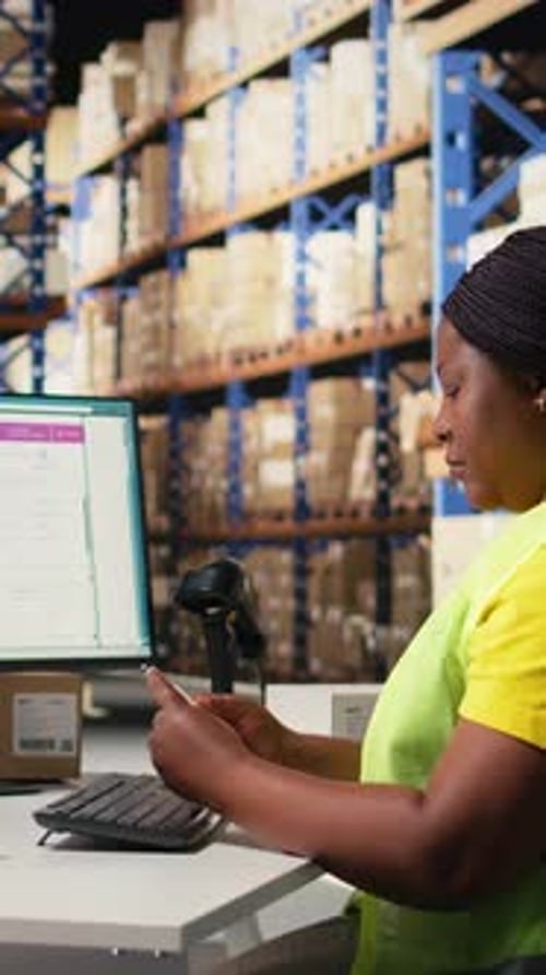 Warehouse Worker Scanning Orders at Computer Terminal