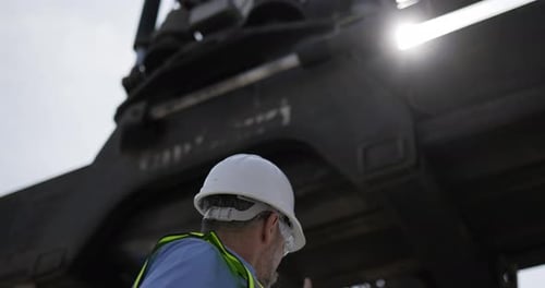 Caucasian Engineer manager control loading while Working In Shipping Port
