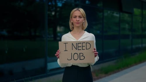 Caucasian Businesswoman Holding Poster Cardboard with Need Job Jobless Message