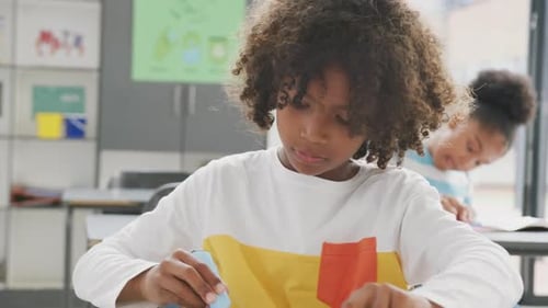 Boy Learning in Classroom with a Blue Marker