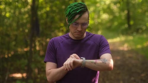 Man Using Smart Watch in Park