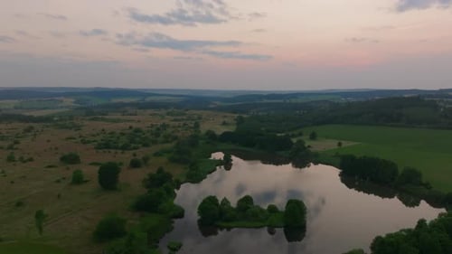 Aerial View of Expansive Forest Lake at Sunset