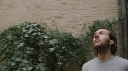 Three people admire architecture in a courtyard