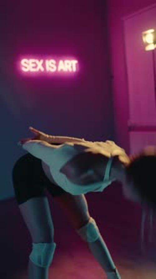 Sensual Dance Performance By a Young Woman in a Neon Lit Studio