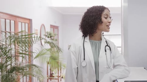 Smiling Doctor in White Coat at Clinic