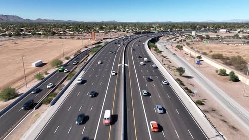 Aerial view of busy highway with cityscape, United States.